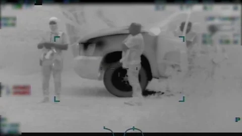 Armed men grouped around escort vehicle at Mexican border Stock-Footage 106865249
