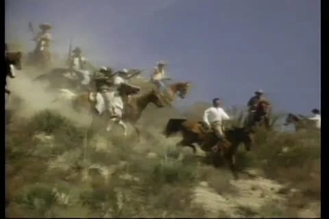 Armed men on horseback riding down mountain Stock Footage 11345318