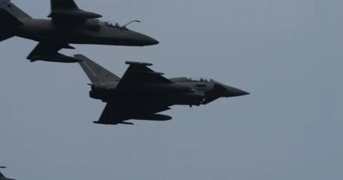 Armed NATO War Jet Planes in Flight in Grey Cloudy Sky Stock Footage 235183864