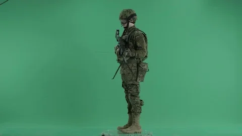 Armed serviceman standing and rounding at green screen Stock Footage 70442321