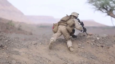 Armed soldier advancing and taking cover Stock Footage 83647951