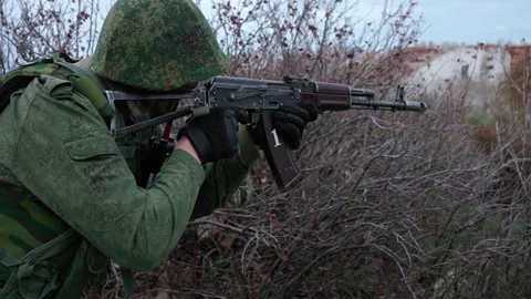 Armed soldier attack enemy in ruined civilian village, military conflict, fight Stock Footage 252994497