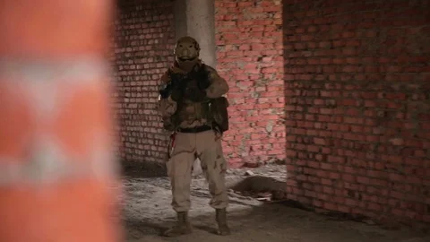 Armed soldier with automatic rifle inbuilding Stock Footage 81672502