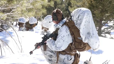 Armed soldiers keep watch during cold weather mountain warfare training Видео 105715926