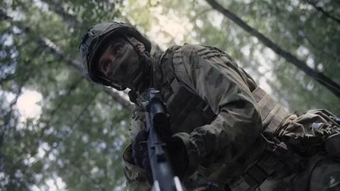 Armed soldiers with rifles, in a dense forest on a special operation Stock Footage 327351956