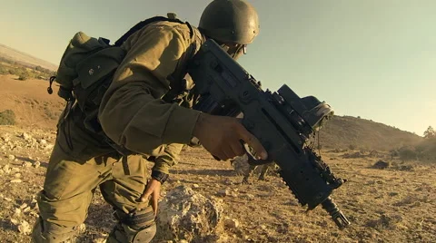 Armed soldiers walking through field. soldiers running with Machine gun weapons. Stock Footage 40290877