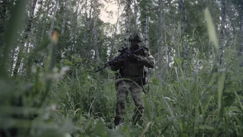 An armed special forces soldier with a sniper rifle in his hands Stock Footage 327353012