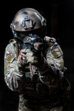 Armed trooper  with machine gun aiming at a target Stock Photos