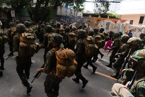 Armed Troops Running with Rucksacks Stock Photos