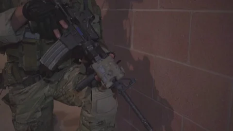Armed U.S. Air Force tactical air control member on guard inside building 動画素材 114059695