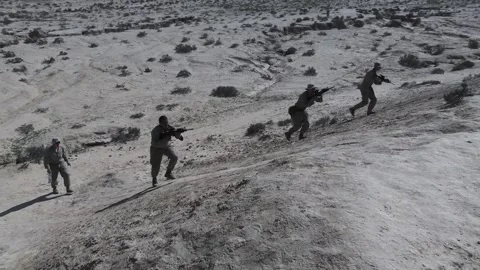 Armed U.S. Marines advancing up sandhill during live fire exercise in Israel Video stock 255568834