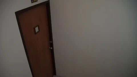 An armed young man in the mask breaks the door and smashes the security camera Video stock 102721749