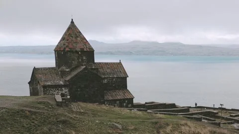 Armenian visitor man person by Sevanavank monastic complex with Lake Sevan .. Vidéo 290066593