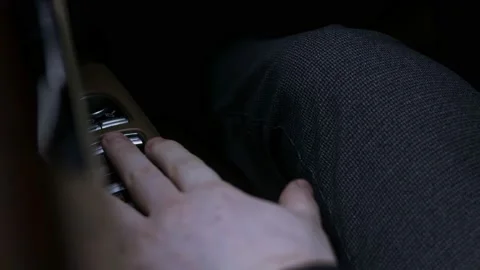 On the armrest the hand presses buttons for the electric elevating mechanism of Stock Footage 145549924