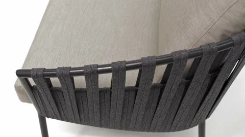 Armrest of a modern outdoor sofa with a weave of dark gray ropes. Stock Footage 220218475