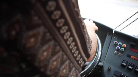 Аrms of bus driver turns the steering wheel closeup Stock Footage 82697136
