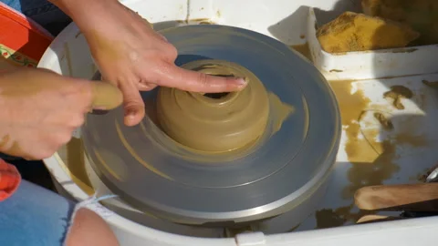 Arms create a vessel on clay wheel. Stock Footage 304760491