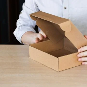 Arms extending open empty cardboard container Stock Photos
