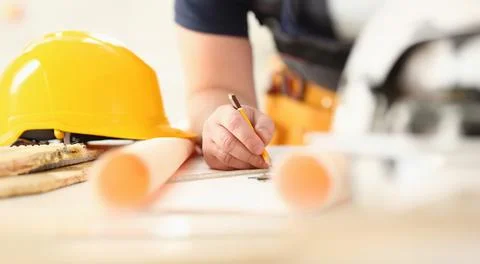 Arms of worker making structure plan 스톡 사진