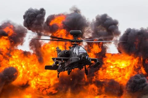 Army Air Corps WAH-64D Apache in front of a wall of fire Stock Photos