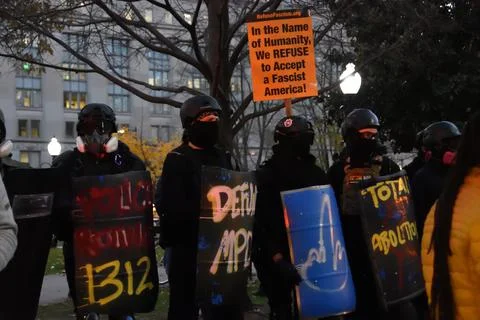 Army of Antifa protesters made shield line formation on the street. Stock Photos
