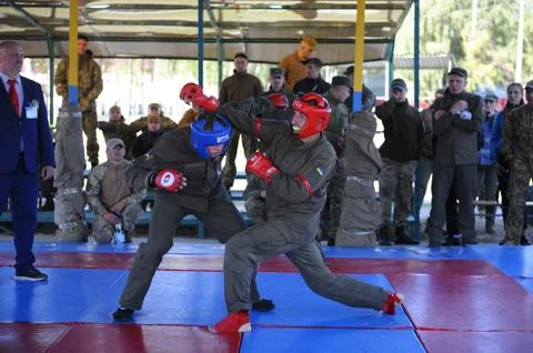 Army combative. Two fighters fighting in a ring, referee watching. An exhibit Stock Photos