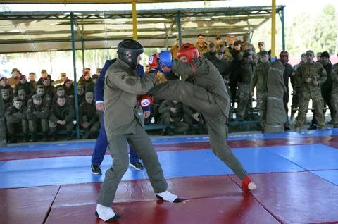 Army combative. Two fighters fighting in a ring, referee watching. An exhibit Stock Photos