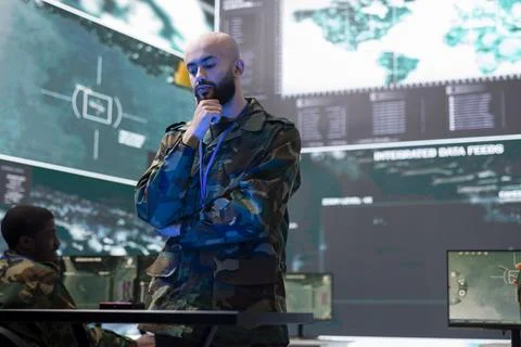 Army conscript studying real time data on a hologram in control center Stock Photos