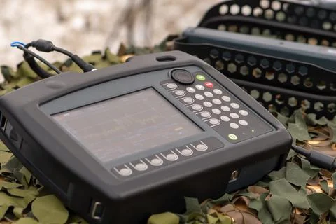 An army electronic device with a display and keys is used to communicate wi.. Stock-Fotos
