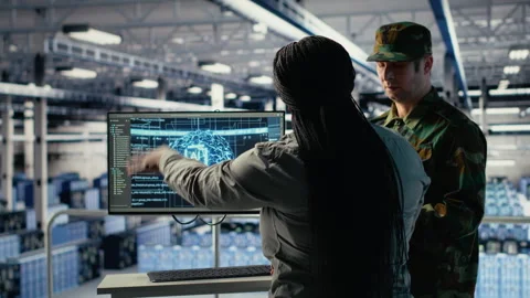 Army experts in server room use artificial intelligence program Stock Footage 314686525