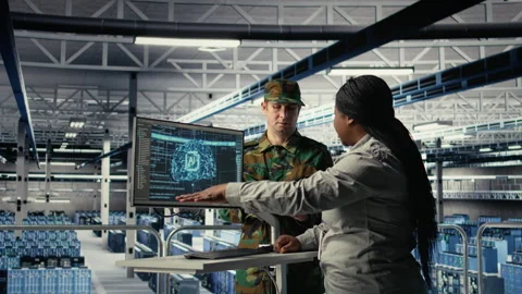 Army experts in server room use artificial intelligence program Stock Footage 314805653
