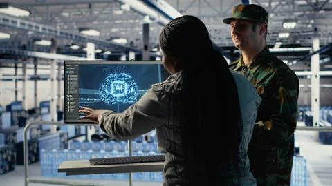 Army experts in server room use artificial intelligence program Stock Photos