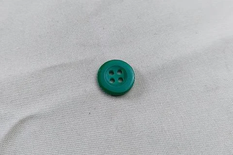 An Army Green button on a fabric texture Stock Photos