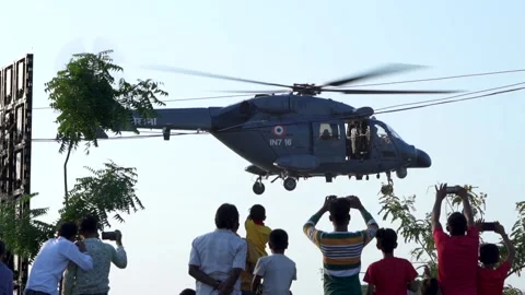 Army Helicopter Hovering and being captured by people crowd - 100fps Stock Footage 220169843