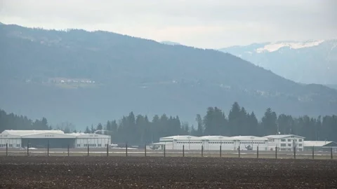 Army helicopter landing in front of the hangars Stock Footage 169812447