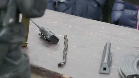 Army instructor showing gun assembling to children Stock Footage 130395549