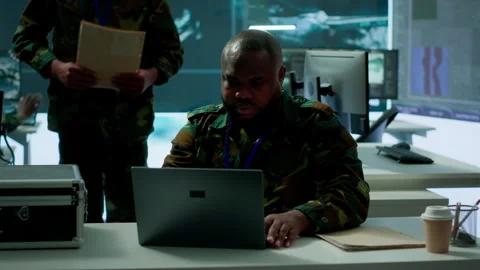Army intelligence expert utilizes modern computer systems and satellite imagery Stock Footage 280147782