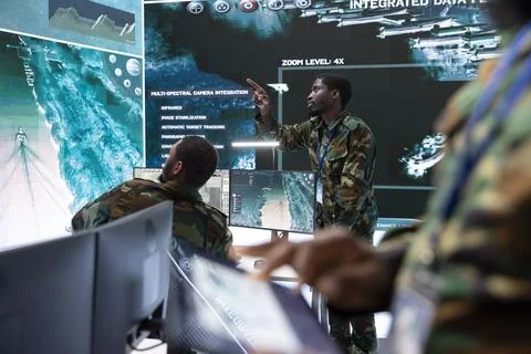Army intelligence specialists use high tech computer systems and satellite data Stock Photos