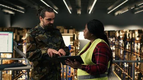 Army logistics team in uniform working in warehouse on military base Stock Photos