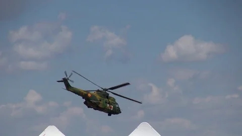 Army medic helicopter flying in the distance on a cloudy afternoon Stock Footage 79592971