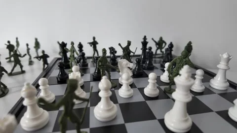 Army Men Figures Beside Chess Pieces on Strategy Board Stock Footage 339660499