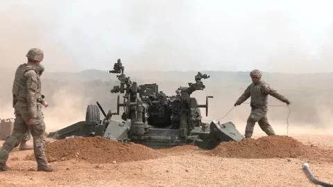Army National Guard soldier pulls trigger and fires M777 Howitzer Stock Footage 257553305