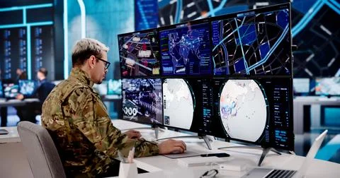 Army Officer Overseeing Several Computer Displays In A High-Tech Command Hub Stock Photos