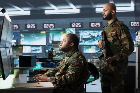 Army operative analyzing surveillance data during international war Stock Photos