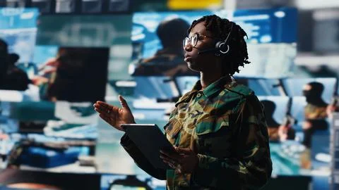 Army operator communicating enemy activity to ground troops Stock Photos