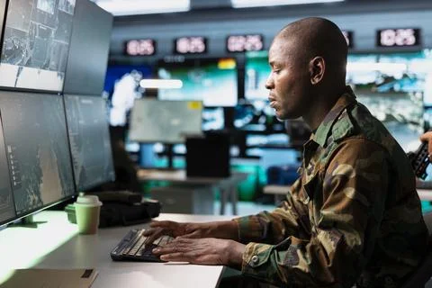 Army operator entering coordinates while monitoring screens Stock Photos