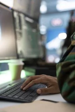 Army operator typing on PC keyboard, conducting tactical reconnaissance Stock Photos
