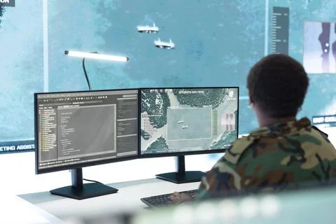 Army operator uses software on computer to gather military target information Stock Photos