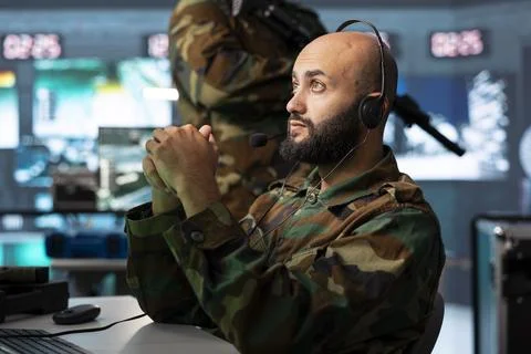 Army operator using audio headset to listen enemy communications Stock Photos