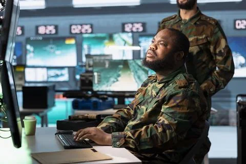 Army operator using computer workstation to review surveillance information Stock Photos